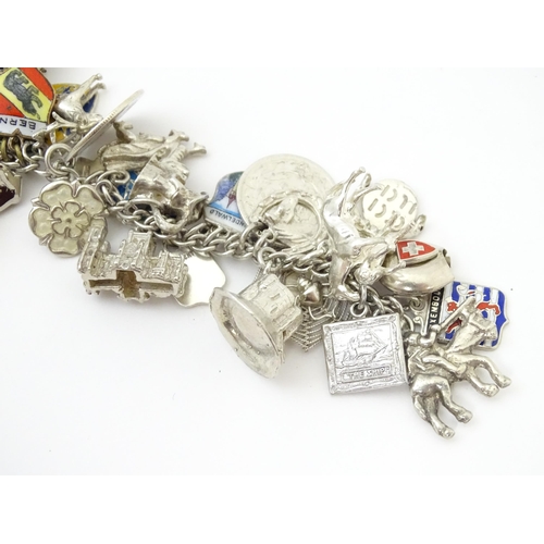 735 - A silver charm bracelet set with various silver, white metal and silver plate charms