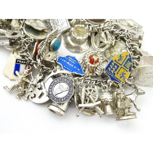 735 - A silver charm bracelet set with various silver, white metal and silver plate charms