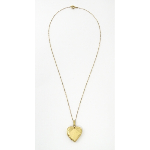 736 - A 9ct gold pendant locked of heart shape, together with a 9ct gold chain. The chain approx 16