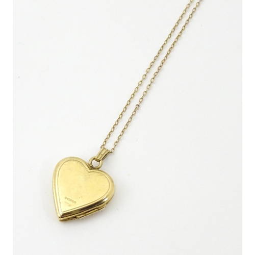 736 - A 9ct gold pendant locked of heart shape, together with a 9ct gold chain. The chain approx 16