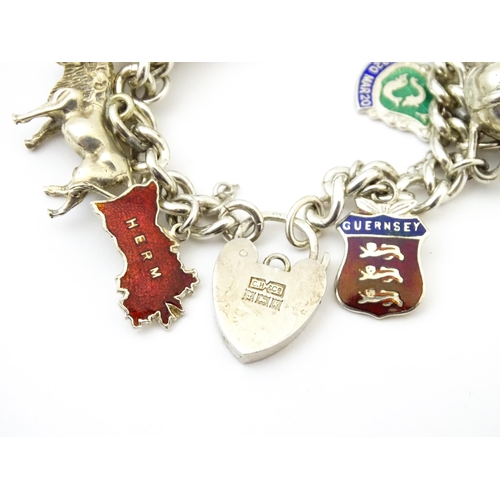 758 - A silver charm bracelet with various silver, white metal and silver plate charms.