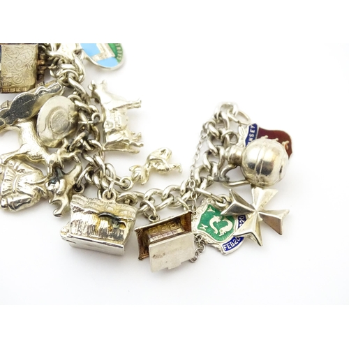 758 - A silver charm bracelet with various silver, white metal and silver plate charms.