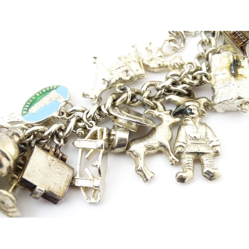 758 - A silver charm bracelet with various silver, white metal and silver plate charms.