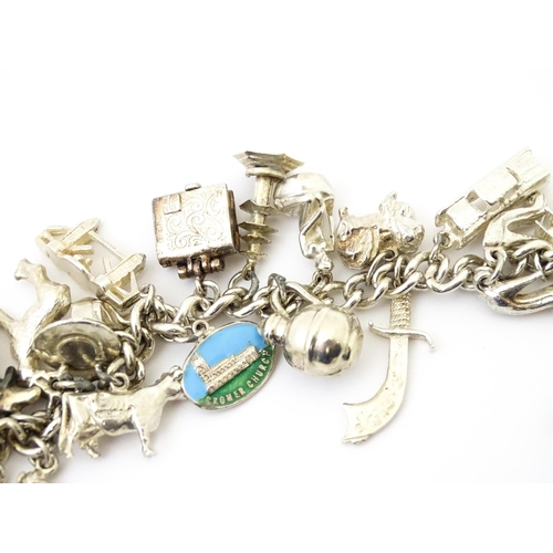 758 - A silver charm bracelet with various silver, white metal and silver plate charms.