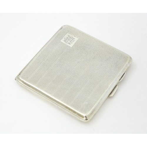 243 - A silver cigarette case with engine turned decoration and gilded interior, hallmarked Birmingham 192... 