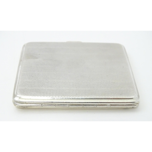 243 - A silver cigarette case with engine turned decoration and gilded interior, hallmarked Birmingham 192... 