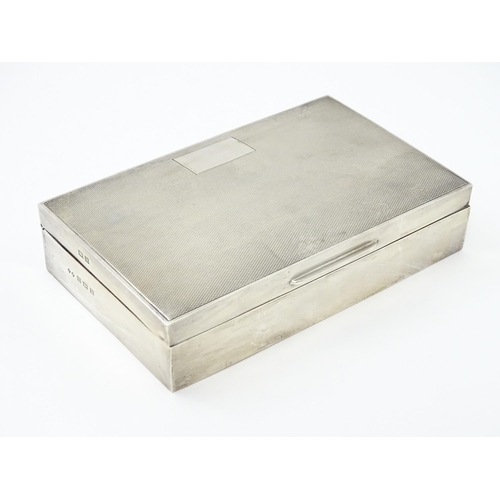 348 - A silver table top cigarette box with engine turned decoration hallmarked Birmingham 1961, maker Fre... 