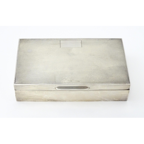 348 - A silver table top cigarette box with engine turned decoration hallmarked Birmingham 1961, maker Fre... 