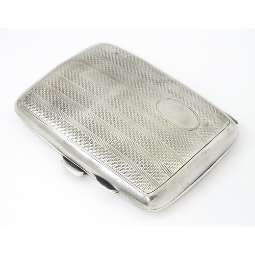 382 - A silver cigarette case opening to reveal faux tortoiseshell lining within. Hallmarked Birmingham 19... 