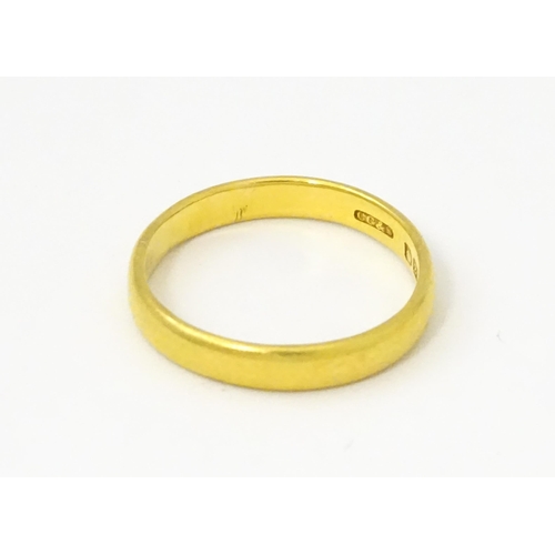 A 22ct gold ring / wedding band. Ring size approx. L 1/2