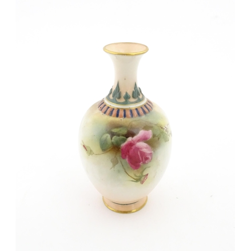 121 - A Royal Worcester vase with hand painted decoration depicting pink and yellow roses, with gilt highl... 