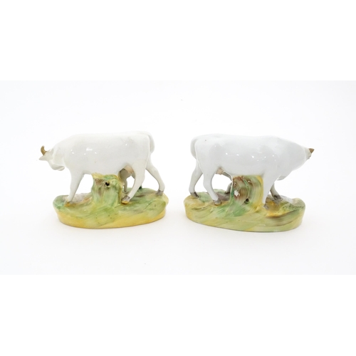 66 - Two Staffordshire models of cow and a calf. Both on oval bases. Approx. 4 1/4