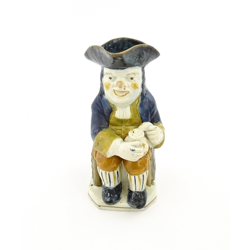 70A - A 19thC Staffordshire pottery character Toby jug decorated in Pratt colours. Approx. 9 1/4