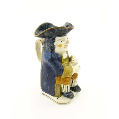 70A - A 19thC Staffordshire pottery character Toby jug decorated in Pratt colours. Approx. 9 1/4