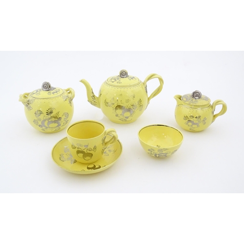 75 - A quantity of Leeds Pottery tea wares with a yellow ground decorated in silver lustre with foliage a... 