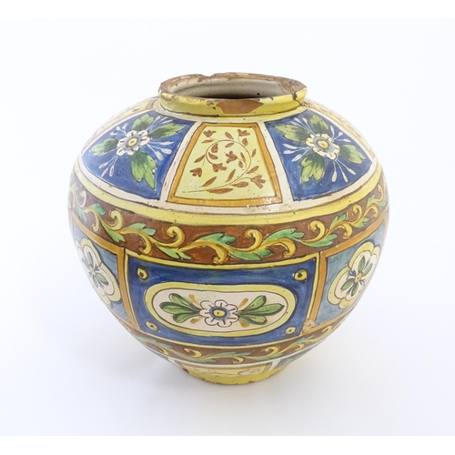 A Sicilian maiolica Bombola vase with panelled and banded decoration depicting flowers and foliage. Approx. 12 1/4" high