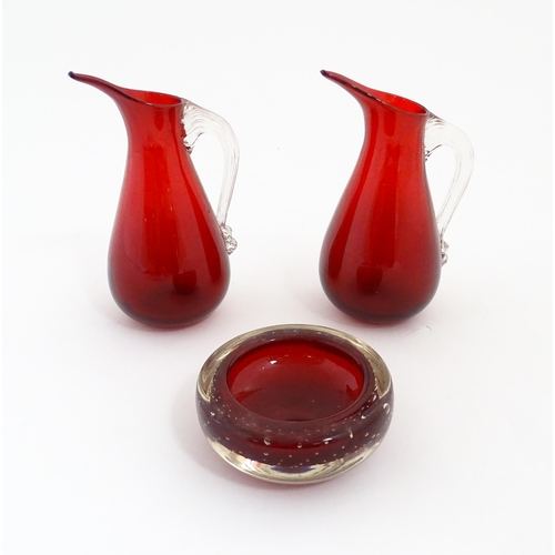 187 - Two Whitefriars ruby glass jugs. Together with a studio glass bowl with controlled bubble detail . J... 