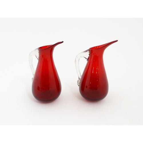 187 - Two Whitefriars ruby glass jugs. Together with a studio glass bowl with controlled bubble detail . J... 