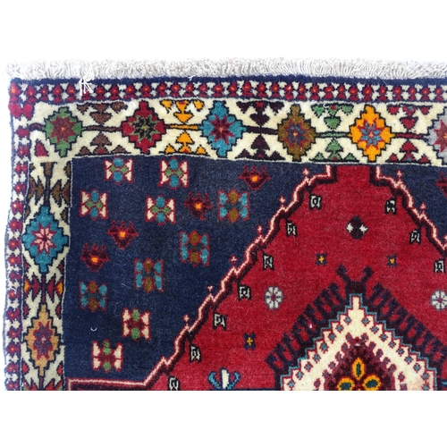 1374 - Carpet / Rug: A South West Persian Qashqai rug the red ground decorated with geometric motifs. Appro... 