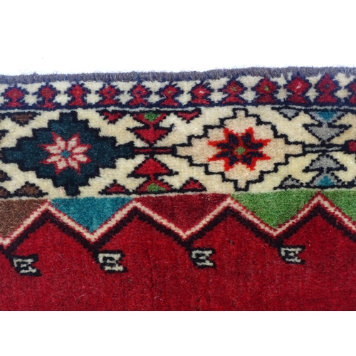 1374 - Carpet / Rug: A South West Persian Qashqai rug the red ground decorated with geometric motifs. Appro... 