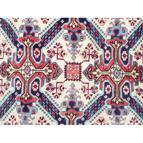 1377 - Carpet / Rug : A Persian Ardebil runner, the cream ground with floral and geometric repeating detail... 