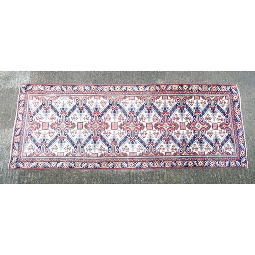 1377 - Carpet / Rug : A Persian Ardebil runner, the cream ground with floral and geometric repeating detail... 