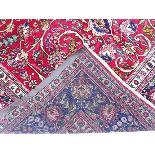 1395 - Carpet / Rug: A North West Persian Tabriz carpet the red ground with central cream and blue medallio... 