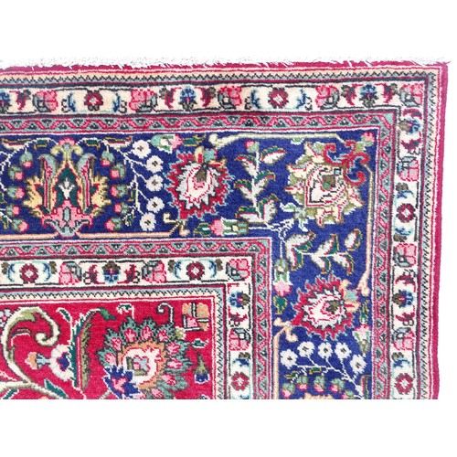 1395 - Carpet / Rug: A North West Persian Tabriz carpet the red ground with central cream and blue medallio... 