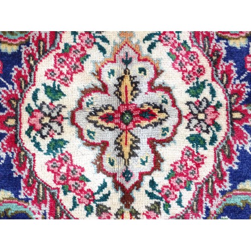 1395 - Carpet / Rug: A North West Persian Tabriz carpet the red ground with central cream and blue medallio... 