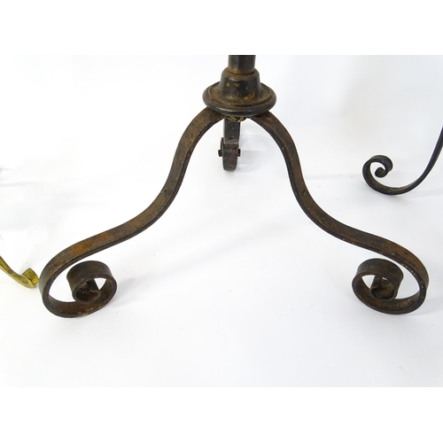 1410 - A 20thC standard lamp with triform base and foliate decoration. Together with two wrought iron style... 