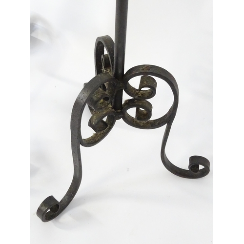 1410 - A 20thC standard lamp with triform base and foliate decoration. Together with two wrought iron style... 