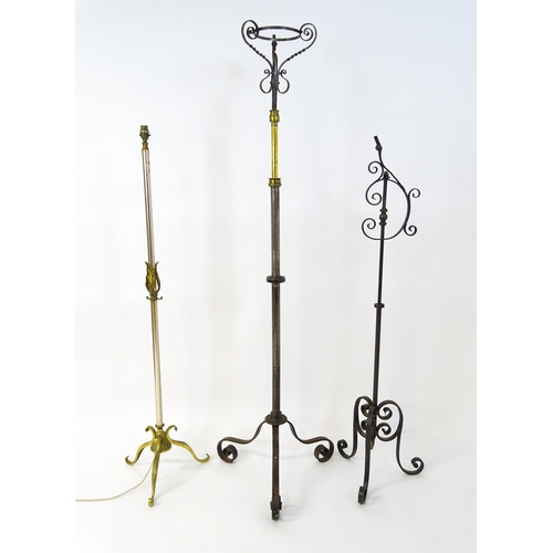 1410 - A 20thC standard lamp with triform base and foliate decoration. Together with two wrought iron style... 