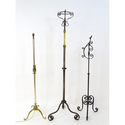 1410 - A 20thC standard lamp with triform base and foliate decoration. Together with two wrought iron style... 