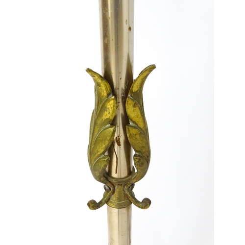 1410 - A 20thC standard lamp with triform base and foliate decoration. Together with two wrought iron style... 