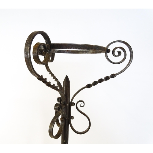 1410 - A 20thC standard lamp with triform base and foliate decoration. Together with two wrought iron style... 