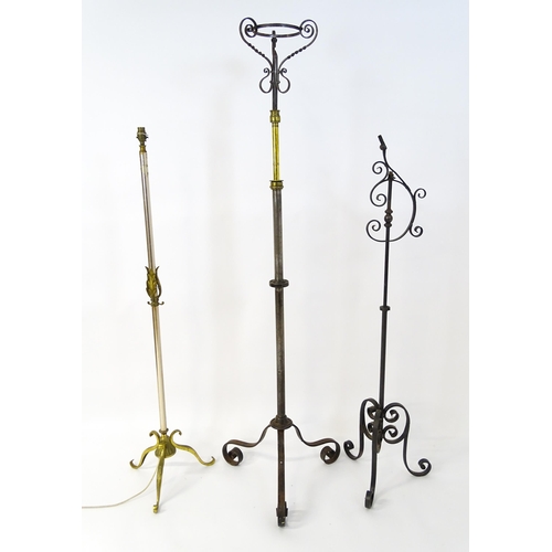 1410 - A 20thC standard lamp with triform base and foliate decoration. Together with two wrought iron style... 