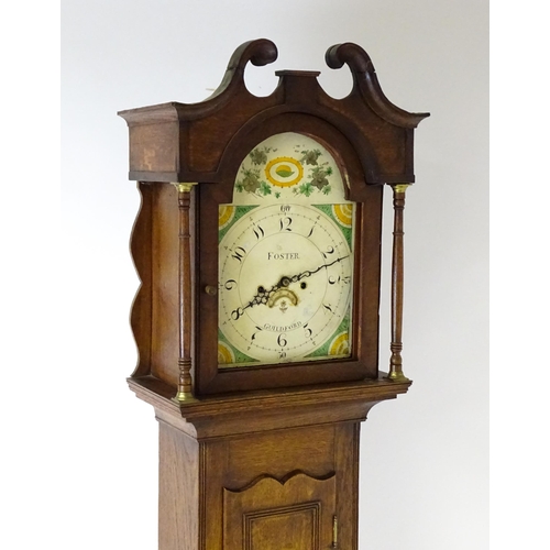 1433 - A 19thC oak cased 8-day longcase clock. The painted arch dial signed Foster  Guildford. The case wit... 