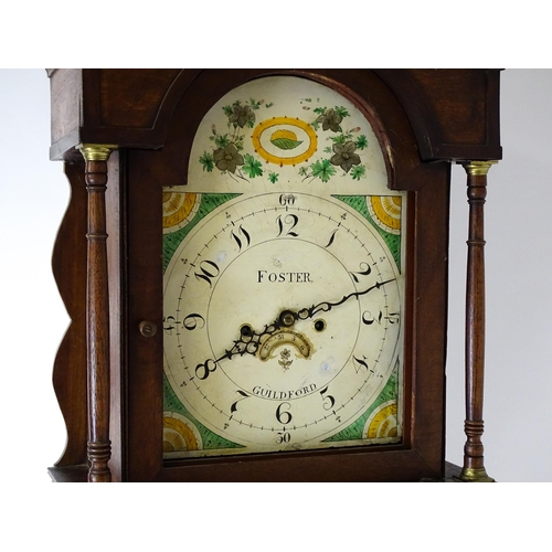 1433 - A 19thC oak cased 8-day longcase clock. The painted arch dial signed Foster  Guildford. The case wit... 