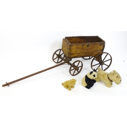 961A - Toys: A late 19th / early 20thC small wooden pull along cart with drawbar and four wheels. Together ... 