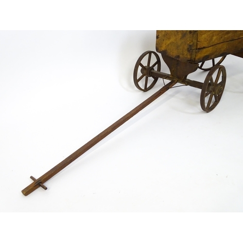 961A - Toys: A late 19th / early 20thC small wooden pull along cart with drawbar and four wheels. Together ... 