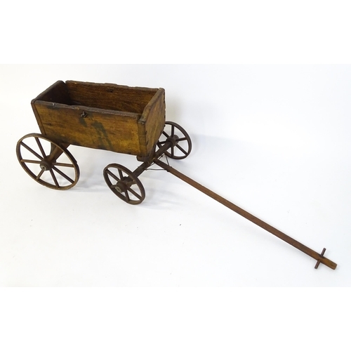 961A - Toys: A late 19th / early 20thC small wooden pull along cart with drawbar and four wheels. Together ... 