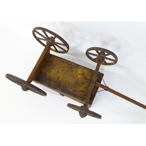 961A - Toys: A late 19th / early 20thC small wooden pull along cart with drawbar and four wheels. Together ... 