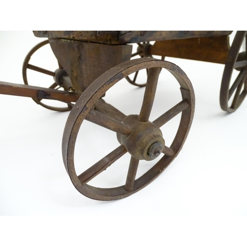 961A - Toys: A late 19th / early 20thC small wooden pull along cart with drawbar and four wheels. Together ... 