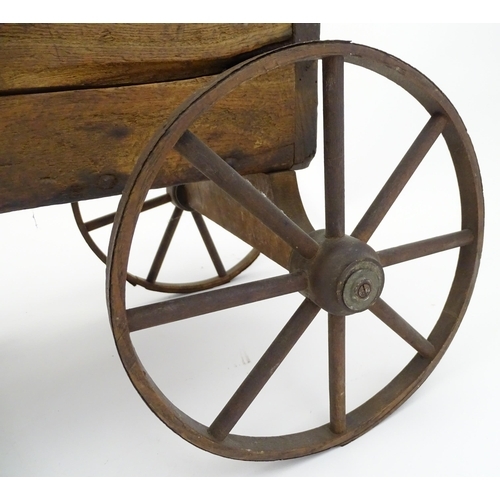 961A - Toys: A late 19th / early 20thC small wooden pull along cart with drawbar and four wheels. Together ... 