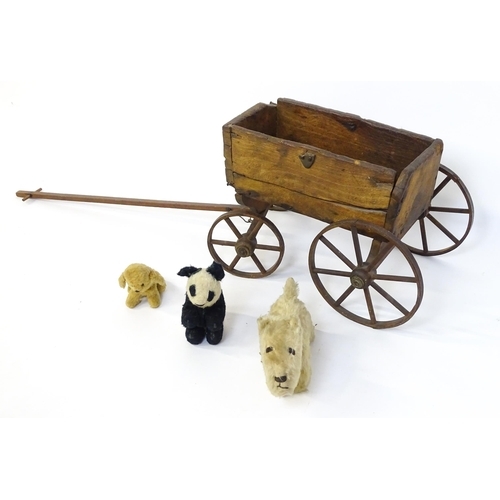 961A - Toys: A late 19th / early 20thC small wooden pull along cart with drawbar and four wheels. Together ... 