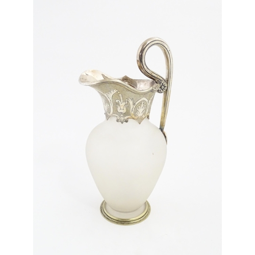 198 - A Victorian frosted glass jug of ewer form with silver plate handle and mounts. Approx. 11 1/2