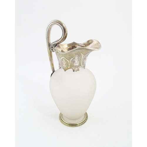 198 - A Victorian frosted glass jug of ewer form with silver plate handle and mounts. Approx. 11 1/2