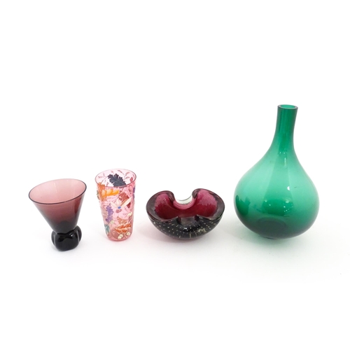 213 - Four items of glassware to include a green bottle vase, an ashtray with controlled bubble detail, a ... 