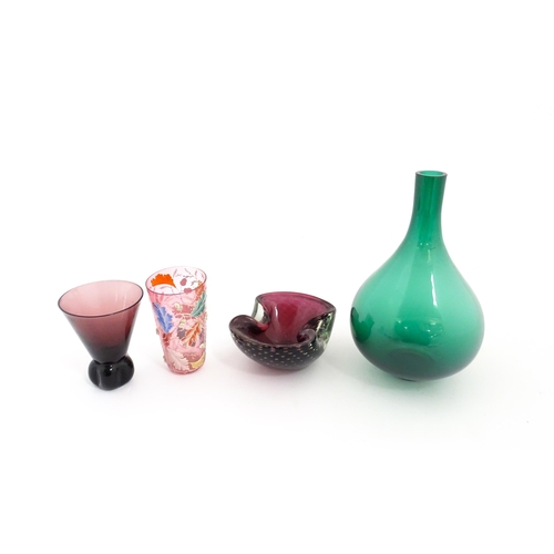 213 - Four items of glassware to include a green bottle vase, an ashtray with controlled bubble detail, a ... 