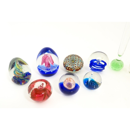 214 - A quantity of assorted art glass paperweights and vases, to include bud vases and a Murano style gla... 